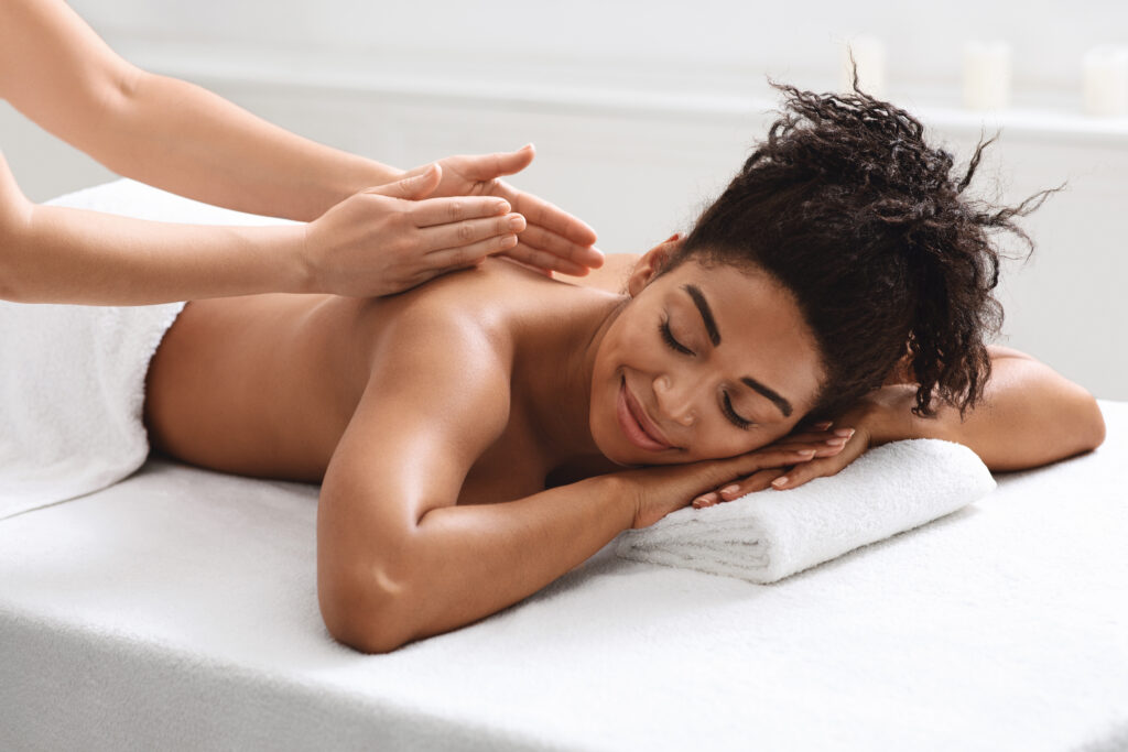 Woman laying on massage table receiving a massage